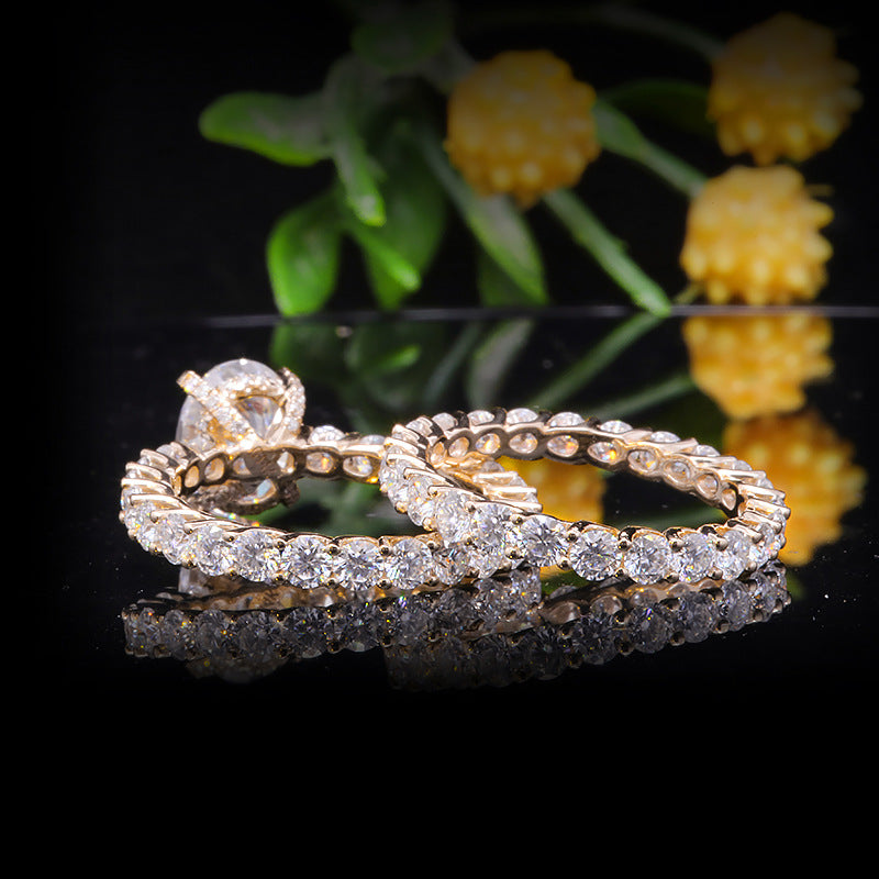 1.5 ct oval Moissanite center stone with side stones, set in 14k yellow gold with matching band