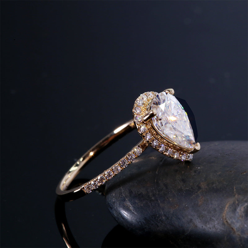 1.5 carat pear cut moissanite wrap halo ring set in pave band